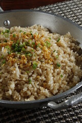 Seasoned rice with spring onions and garlic chips