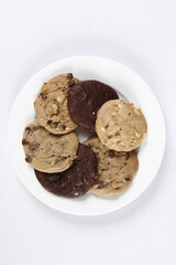 assorted chocolate cookies on a white plate