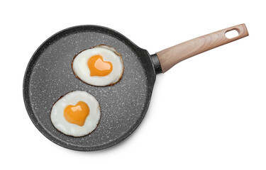 Frying pan with tasty fried eggs with yolks in shape of heart on white background, top view