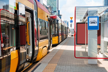 Modern streetcars near tram stop on sunny day. Public transport - obrazy, fototapety, plakaty
