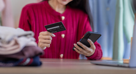 Start up small business entrepreneur SME freelance asian woman work from home her hand holding credit card with box, online marketing packaging mail box and delivery, SME e-commerce concept
