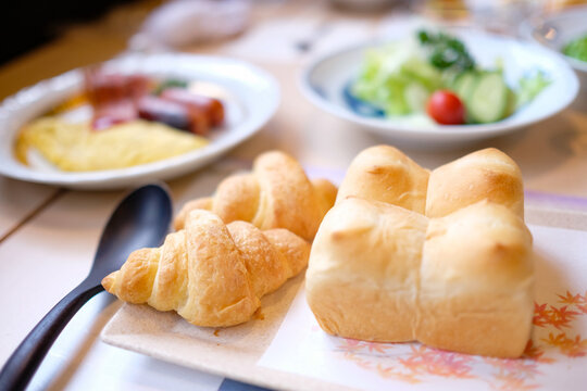 Croissants and freshly baked bread, omelette, sausages and bacon, fresh salad as part of a typical Japanese-style Western breakfast at a Hakone ryokan — Sengokuhara, Kanagawa Prefecture, Japan