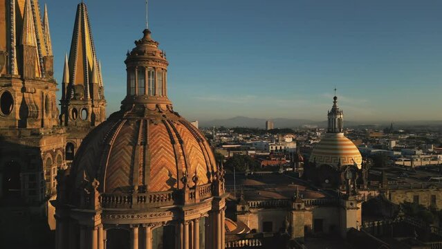Beautiful sunset above the square with gothic spires towering the city. Drone footage of Plaza Guadalajara with cinematic views on the Cathedral. High quality 4k footage