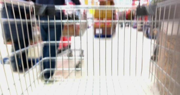 Time lapse abstract blurred ride with shopping trolley in German supermarket