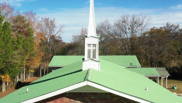 Baptist country church steeple with autumn colors mountain  in Scottsboro Alabama USA.
