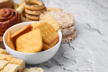 Different gluten free products on light grey textured table, closeup. Space for text