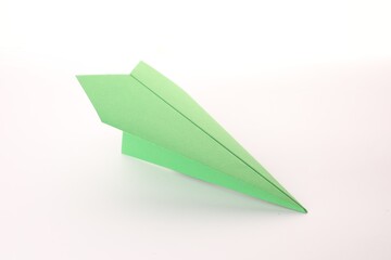 Handmade green paper plane isolated on white