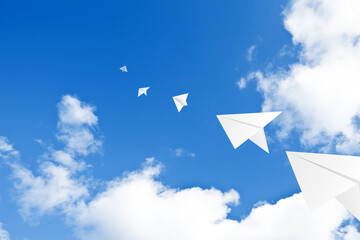 paper airplane flying in the sky
