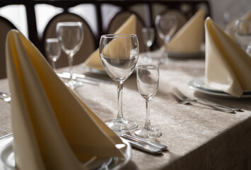 empty goblets and other cutlery are served on the festive table.