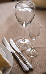 empty goblets and other cutlery are served on the festive table.