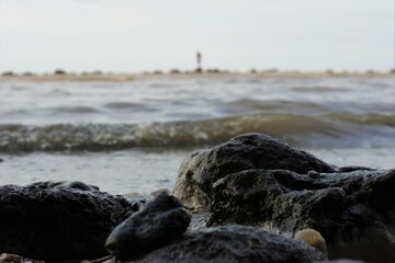 Shot of waves on the kartini beach, rembang, central java, Indonesia. sea stock. looks like a fisherman in the distance.