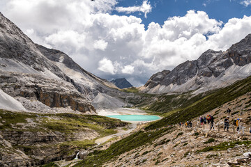 Fototapeta premium Nature scene trekking of landscape Milk Lake yading at Yading national reserve.It is Beautiful lake color like a milk blue . Daocheng County , Sichuan Province , China - Blue nature backdrop Travel