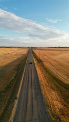 Fototapeta na wymiar Drone view during sunrise over a farm hay field and river in Alberta Canada