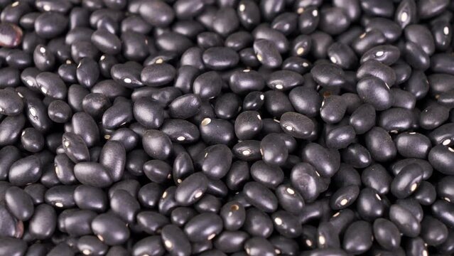Close-up shot of spinning black beans close up.