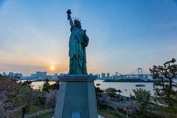 Obraz premium Sunny view of the Rainbow Bridge and Odaiba Statue of Liberty