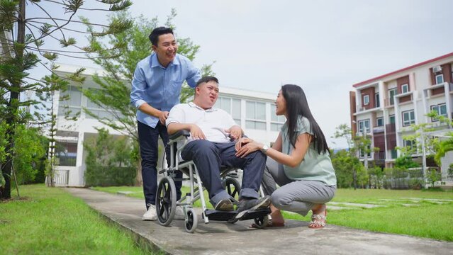 Asian attractive family, parents playing with young son in the garden.