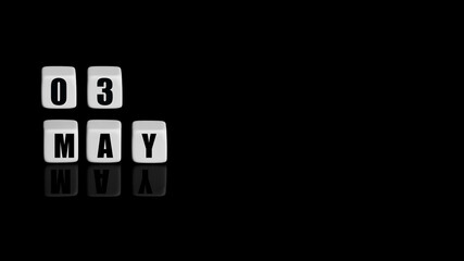 May 3th. Day 3 of month, Calendar date. White cubes with text on black background with reflection.Spring month, day of year concept