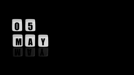 May 5th. Day 5 of month, Calendar date. White cubes with text on black background with reflection.Spring month, day of year concept