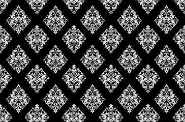 Floral pattern. Vintage wallpaper in the Baroque style. Seamless vector background. White and black ornament for fabric, wallpaper, packaging. Ornate Damask flower ornament