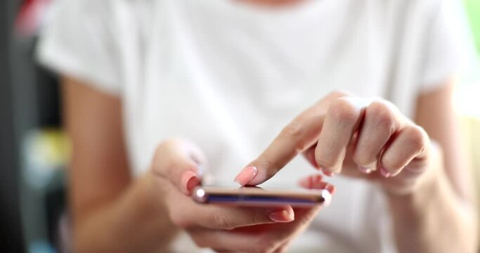 Woman is typing text message on smartphone or scrolling through social media feed