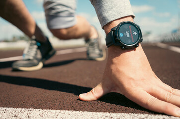 man is preparing to start on a treadmill. smart watch on the athlete's hand. Applications for...