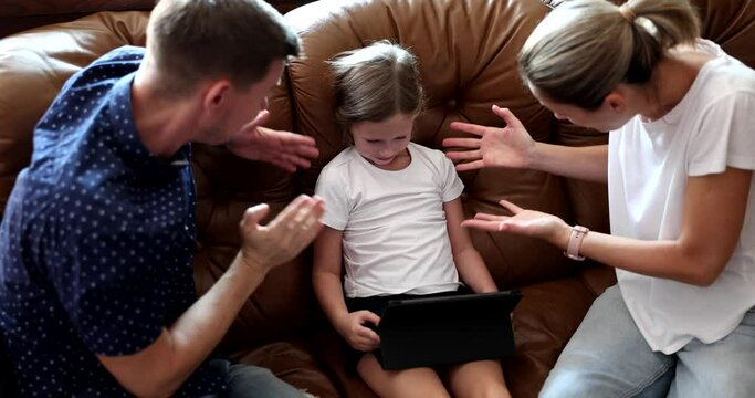 Parents mom and dad scold shouting at child with tablet