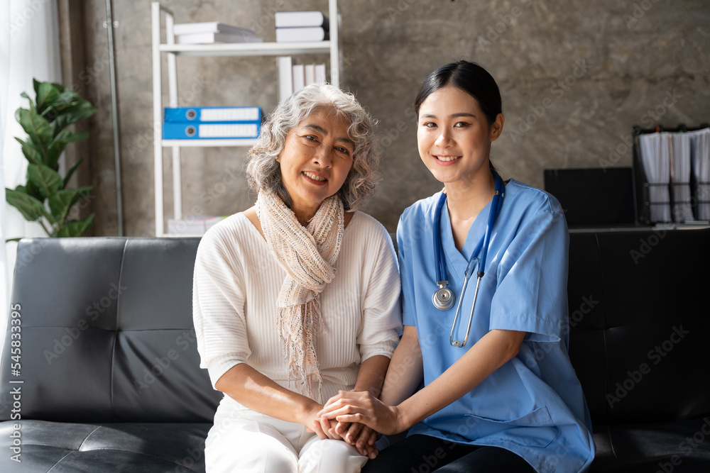 Wall mural asian young nurse supporting elderly patient disabled woman in hospital. elderly patient care concep