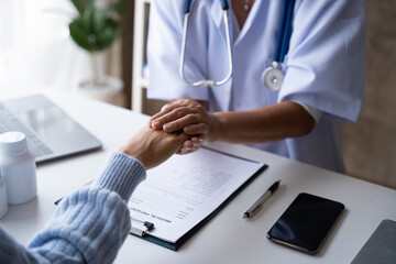 Fototapeta premium Doctor with patient in medical office, Mature woman with her doctor in hospital talking about healthcare.