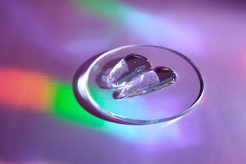 Smear of gel cosmetics product in petri dish on holographic background with iridescent highlights
