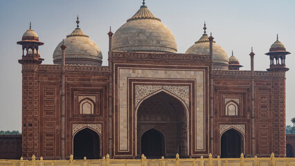 The ancient red sandstone mosque of the Taj Mahal complex. Decorated with white marble and inlays....