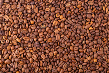 Coffee beans background. Fresh coffee beans, top view. Arabica and Robusta grains. Texture, wallpaper.