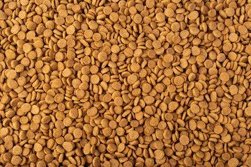 Dry pet food background. Crispy pet food, top view. Texture, wallpaper.