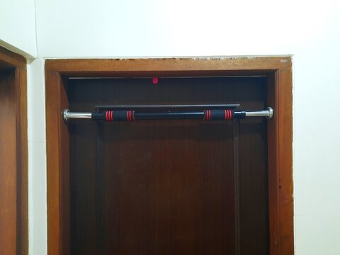 Pull-up bar on a door frame. Closed door.
