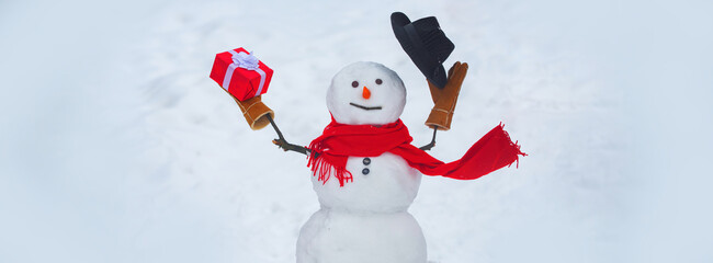 Greeting snowman. Handmade snowman. Christmas snowman with Christmas gift. Hello winter. Happy...