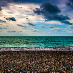 Stony coast of the azure sea close-up.