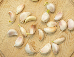 Fresh garlic cloves on a wooden background