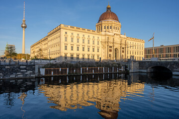 The rebuilt Berlin City Palace with a refelction in a small canal and the famous Television Tower