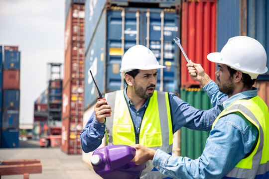 Screaming builder in helmet. Handsome man holding wrench and walkie talkie. Shipment worker in hard hat. Builder working with construction helmet. 
Argue and quarrel concept