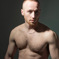 Fototapeta premium Portrait of stylish handsome young man. Fashion guy. Naked body, nude bare torso.