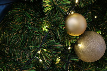 The Christmas tree is decorated with colorful toys and lights.