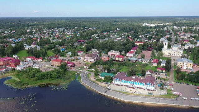 Scenic summer view from drone of ancient town of Myshkin located on steep left bank of Volga overlooking modern river station and medieval temples, Russia