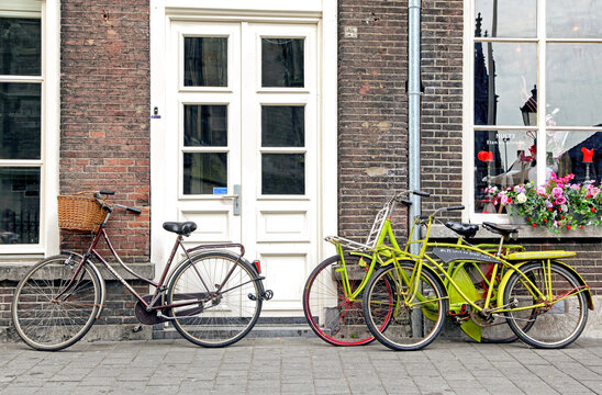 Old bicycles in front of typical house in city s Hertogenbosch in Netherladns