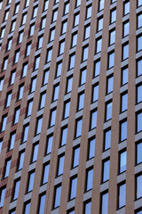 Facade of a high-rise brick building with windows.