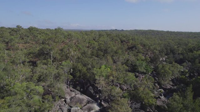 Granite Boulders And Vegetation At Granite Gorge Nature Park In Queensland, Australia - aerial pullback