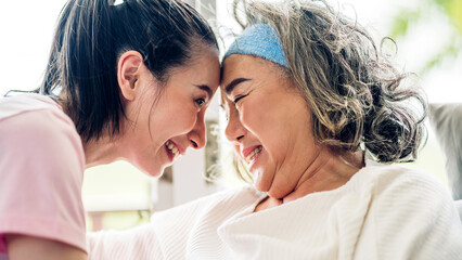 Portrait of enjoy happy love asian family senior mature mother and young woman daughter smiling laughing embracing and having fun hug together.happy family in moments good time at home