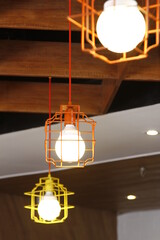 Closeup of colorful hanging light bulbs encased in metal frames
