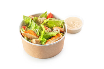 Caesar salad in paper bowl with lid for take away, isolated on white background