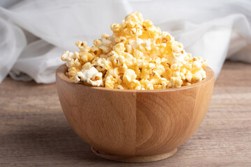 Popcorn in a wooden cup. Snacks.