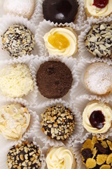 Assorted cream puffs in different flavors
