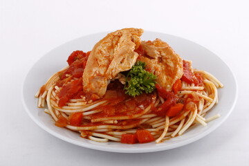 Closeup of chicken pasta with tomato chunks